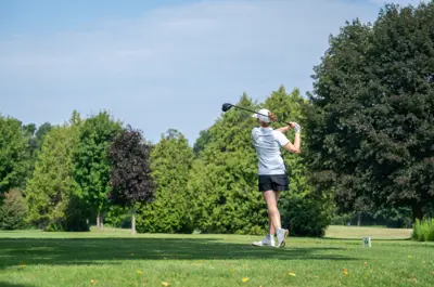 Young golfer watching their tee shot