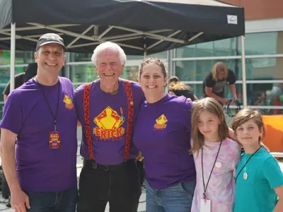 Group of adults posing with Erick Traplin