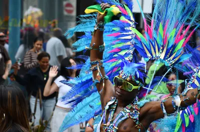Revellers in colourful costumes walking down King Street