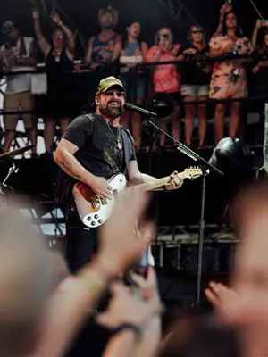 performer on stage playing guitar
