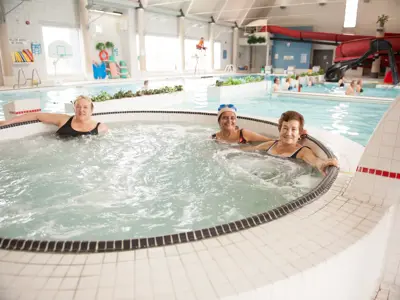 senior people in indoor hot tub at swimming pool