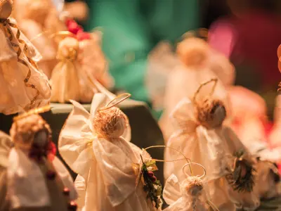 Table filled with handmade fabric angel decorations