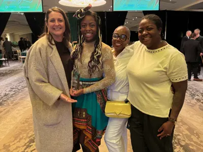 Councillor posing for photo with group of women