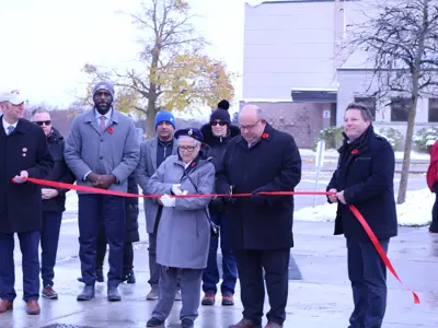 Mayor and council at ribbon cutting ceremony cutting the ribbon