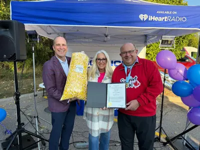 Mayor and councillor posing with popcorn and a certificate