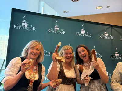 City councillors posing for photo at Oktoberfest with pretzels