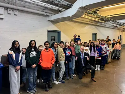 Councillor posing with thumbs up with kids