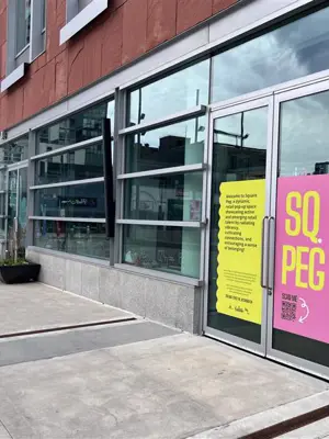 Front of building with Square Peg written on the door