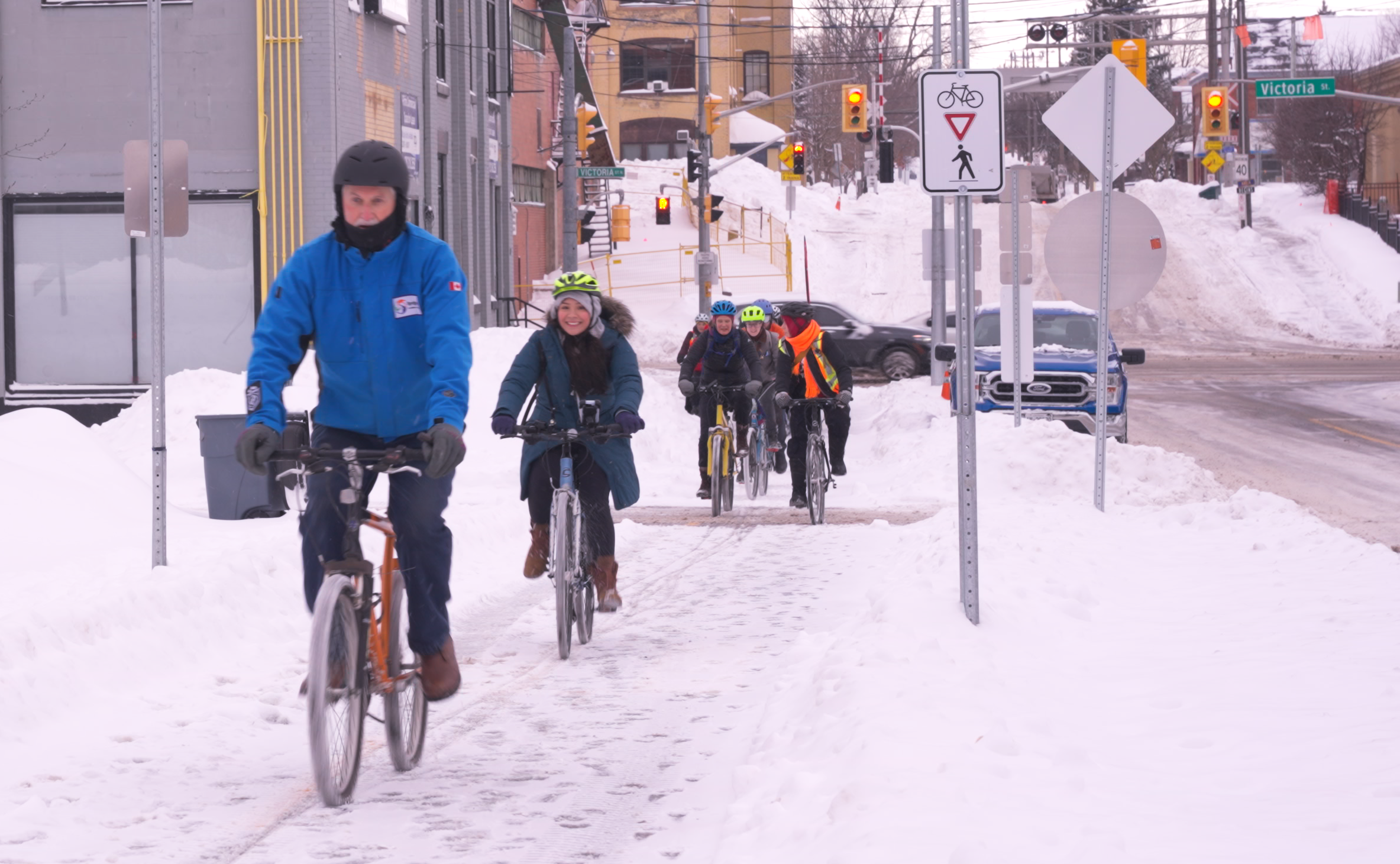 people riding bicycles in the snow