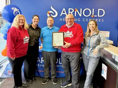 mayor and council posing for photo with business owners