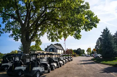 Golf carts sitting outside the clubhouse at Doon Valley Golf Course