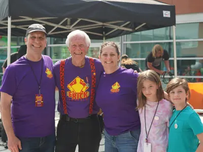 Council and kids posing for photo with child performer at event