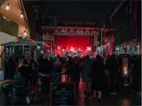 Band plays on stage at night performance