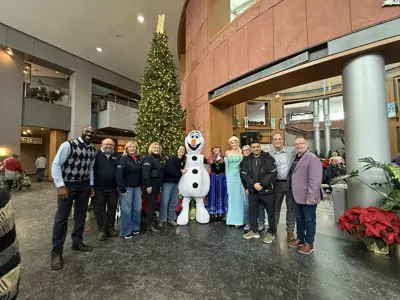 City council and mayor posing for photo with characters from movie Frozen