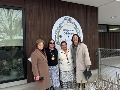 Councillor and other dignitaries posing for photo in front of building