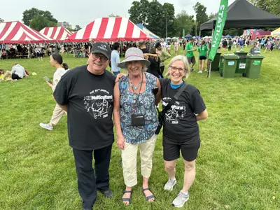 Councillor posing with community members at outdoor festival