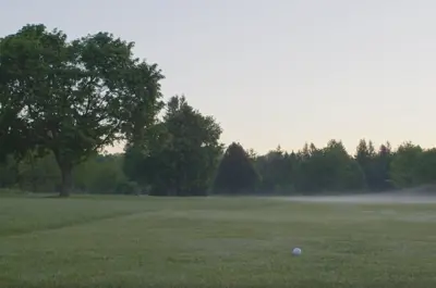 Looking down the fairway towards a hole with fog in the background
