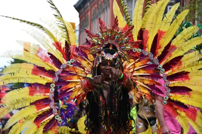 Revellers in colourful costumes walking down King Street