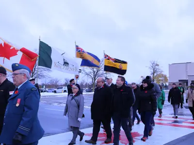 adults walking across a painted crosswalk with flags