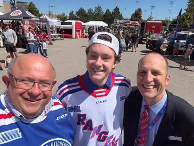 Mayor and councillor posing with hocket player