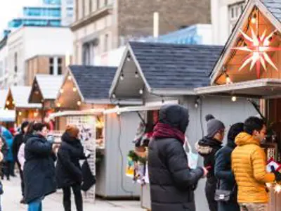 People shopping at market stalls in daylight