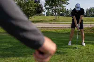 Group of golfers teeing off