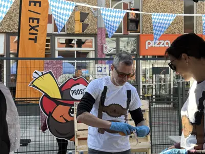Councillor serving sausages at Oktoberfest