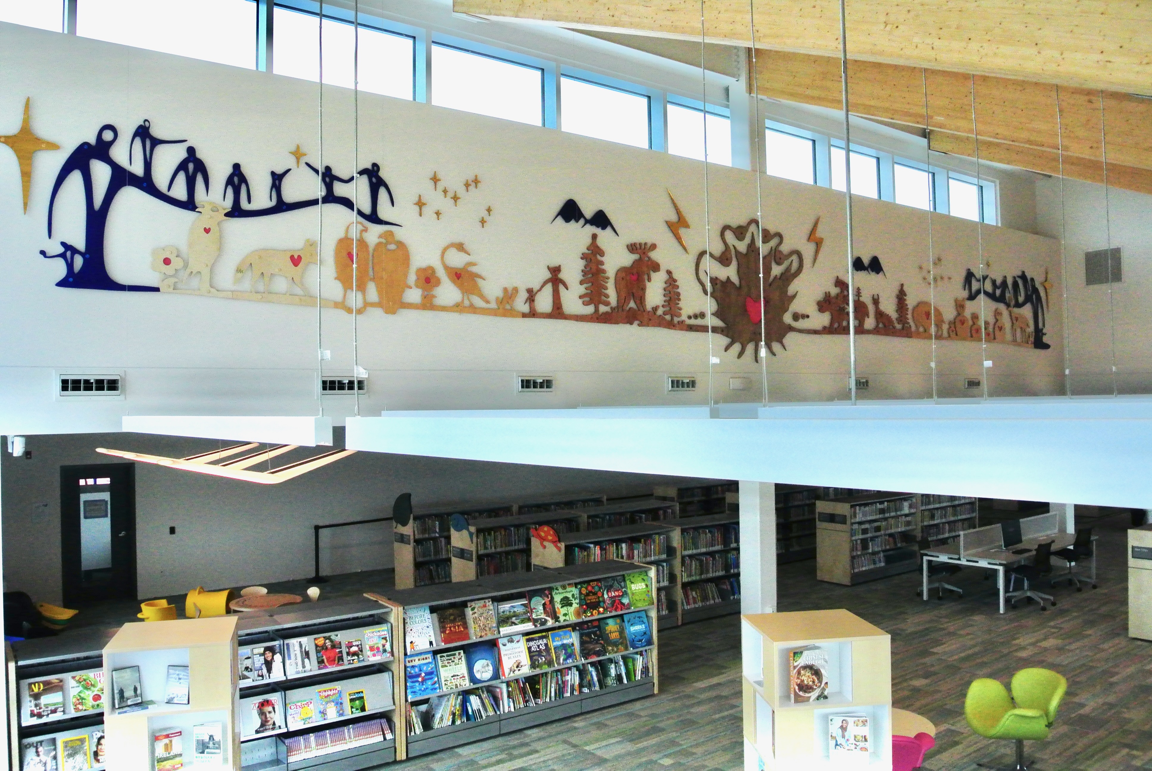 Artwork mounted on the wall of an atrium above the main floor of the library