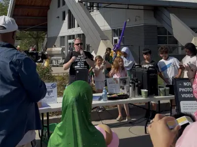 Councillor speaking to group of people outside of community centre