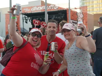 People cheering in Canada gear at festival