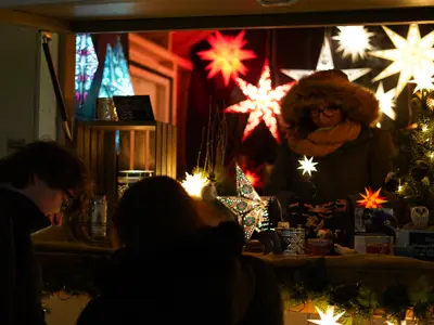 christmas vendor booth lit up at night