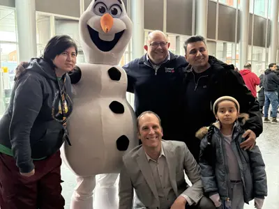 Council and youth posing for photo with mascot dressed as a snowman