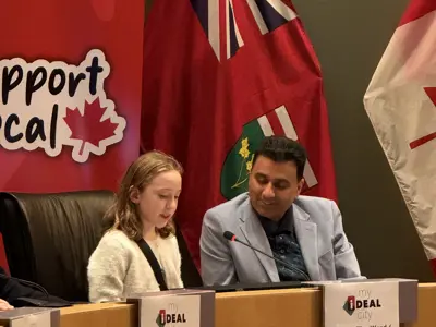 Councillor sitting with youth in council chambers