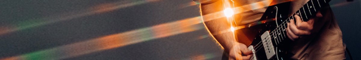 Person playing guitar with a lens flare effect