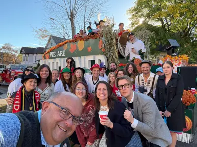 mayor and council posing for selfie in front of parade float