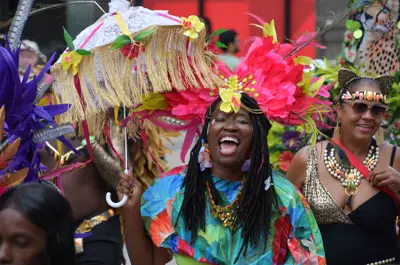 Revellers in colourful costumes walking down King Street